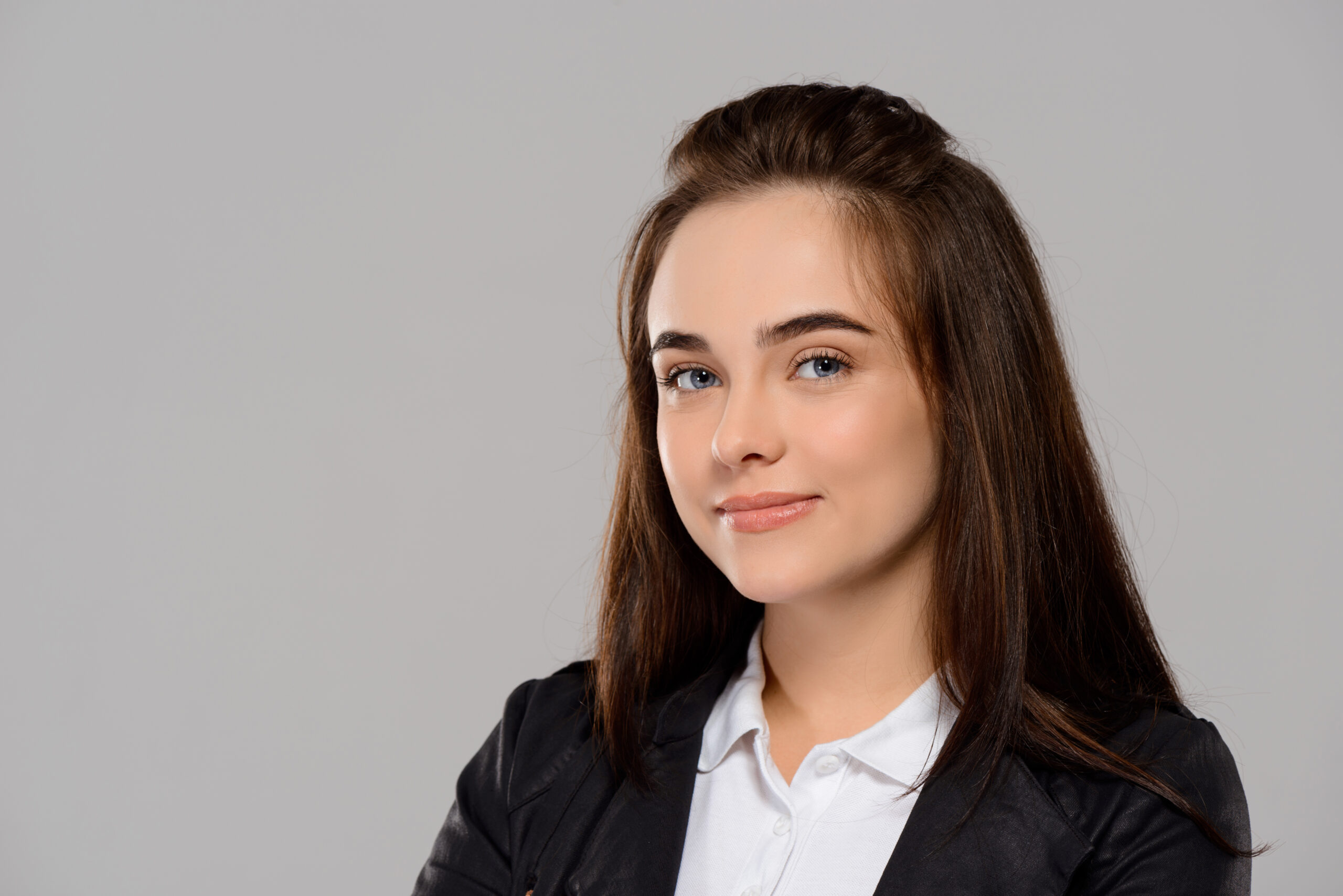 Young beautiful girl smiling, posing, looking at camera over purple background. Copy space.